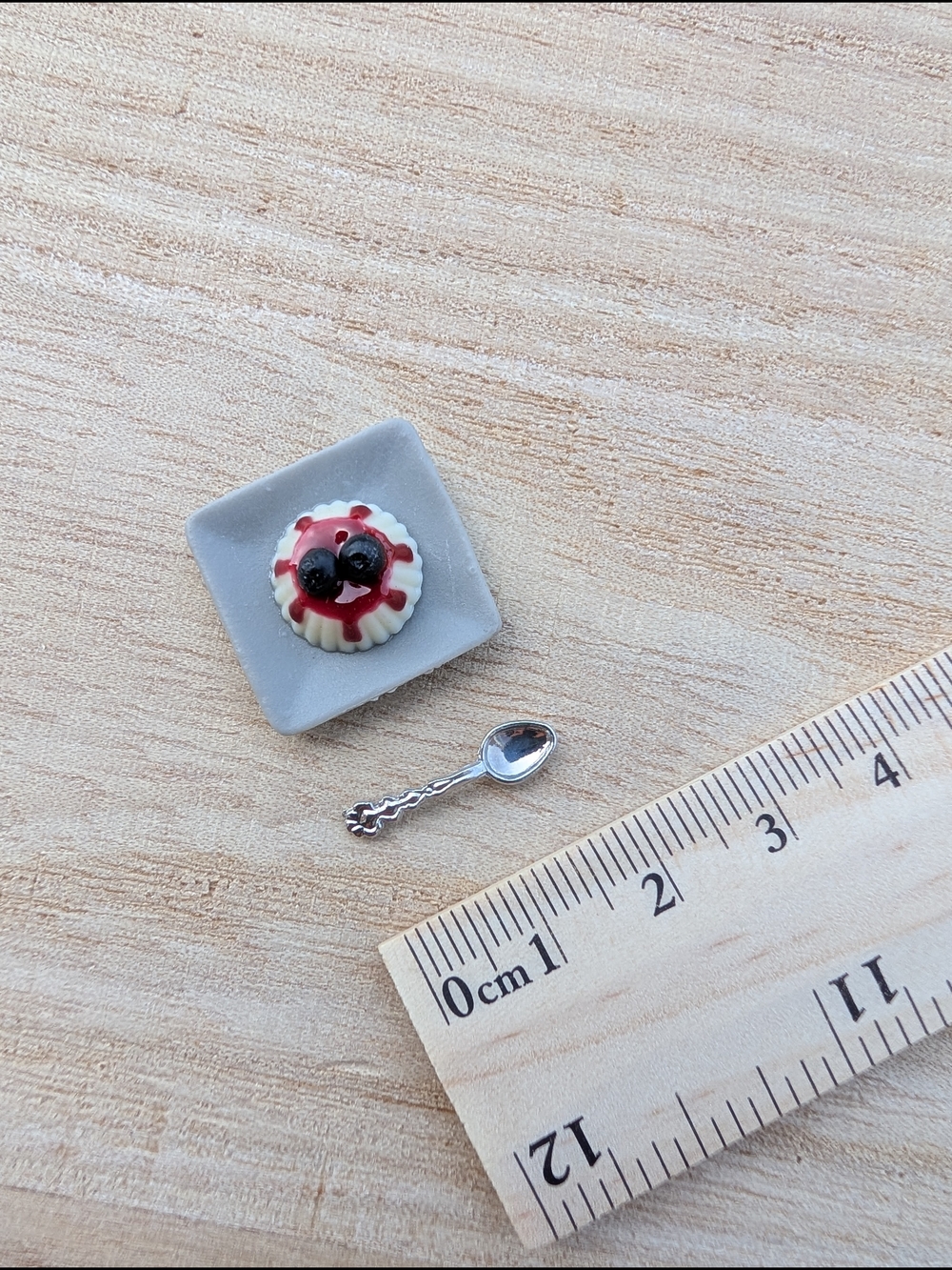 Miniature Berry Tart on Gray Plate with Tiny Silver Spoon